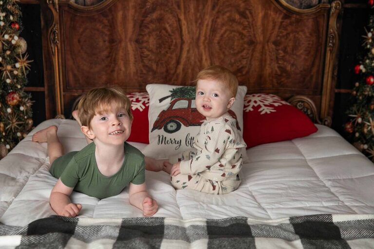 holiday Christmas sessions with a bed set up and holiday pajamas