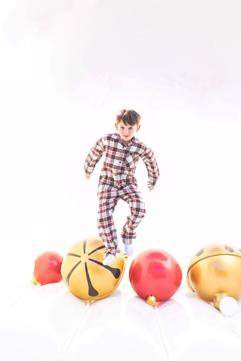 boy jumping in white bounce house session