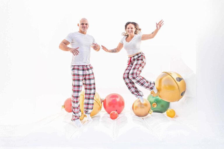 parents jumping in white bounce house holiday session