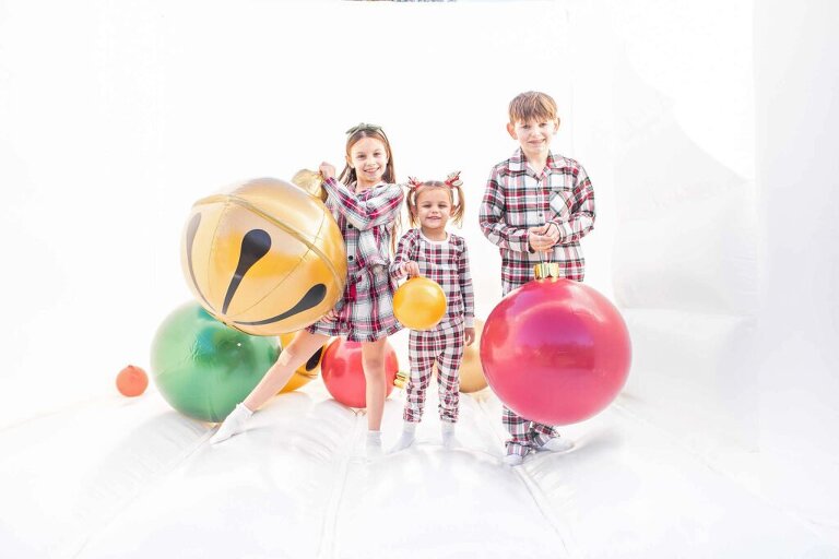 children holding giant ornaments in our holiday bounce house