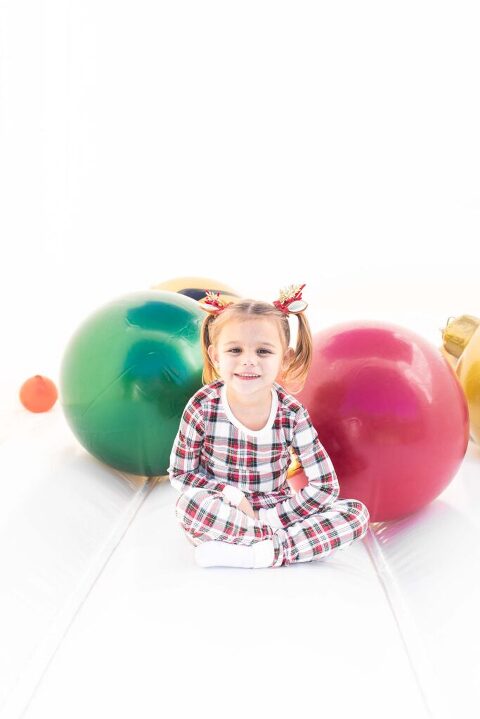 little girl in holiday PJs during our christmas bounce house sessions
