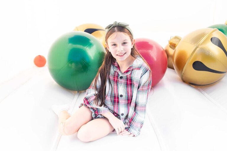 girl in our christmas holiday bounce house with giant ornaments