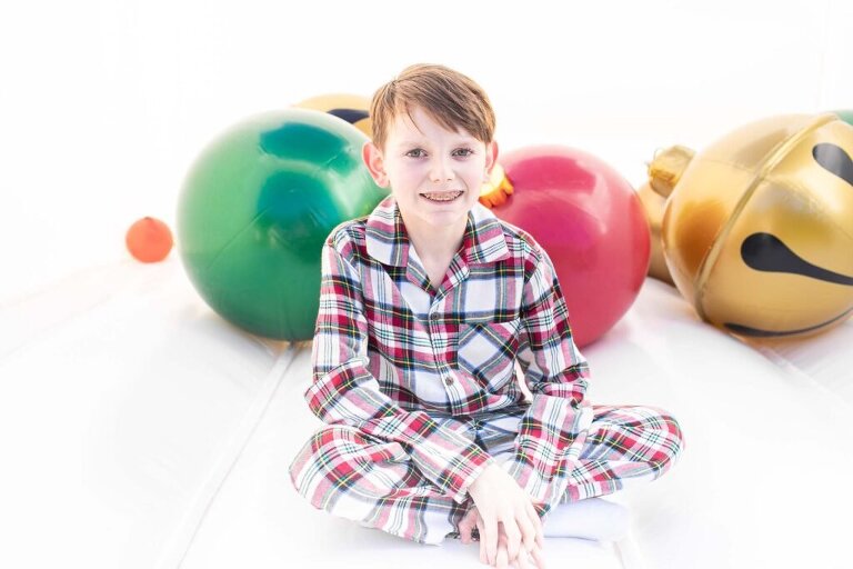 young boy in our holiday bounce house christmas set up 